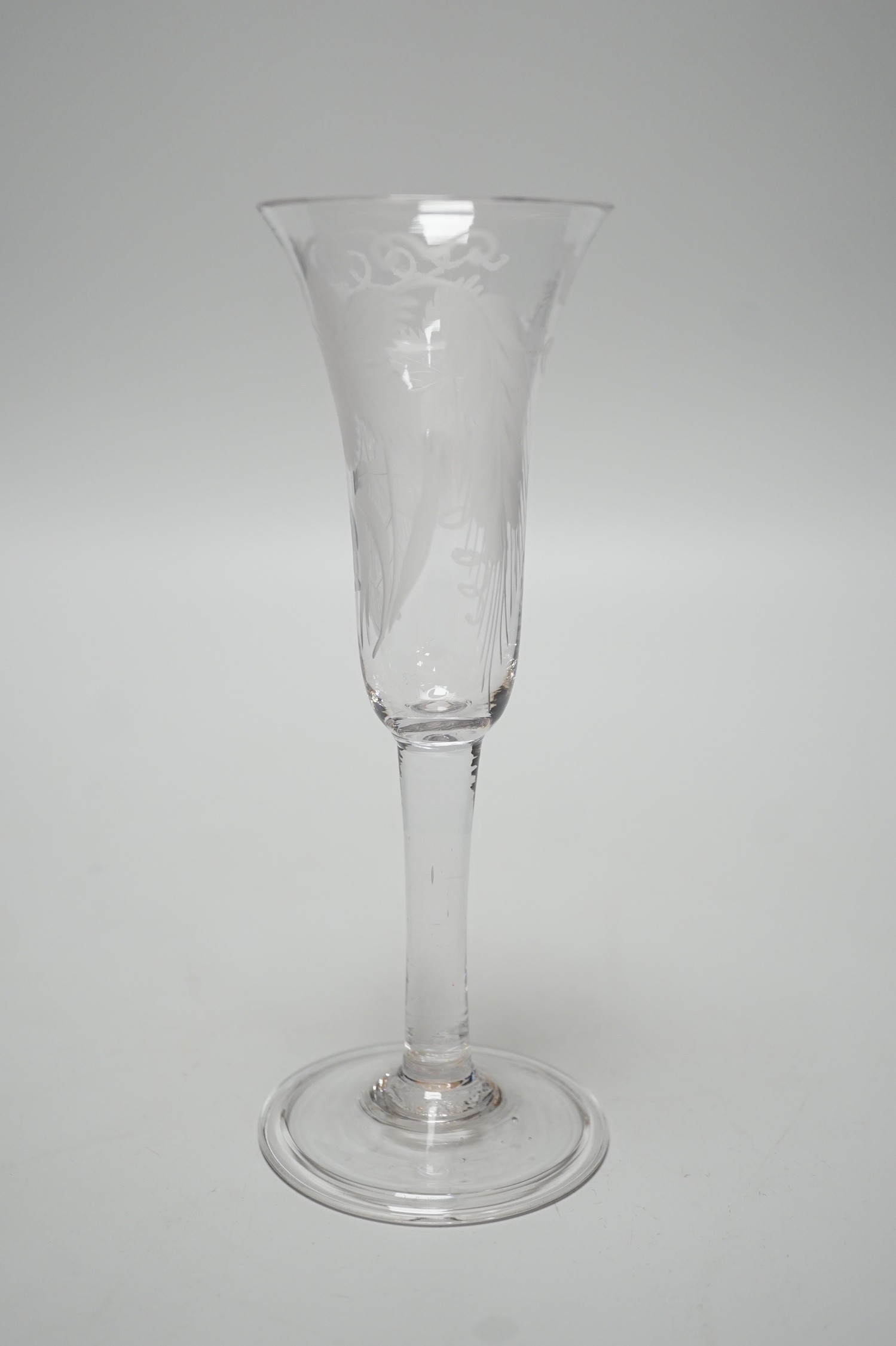An 18th century engraved ale flute, folded foot, 19.5cms high